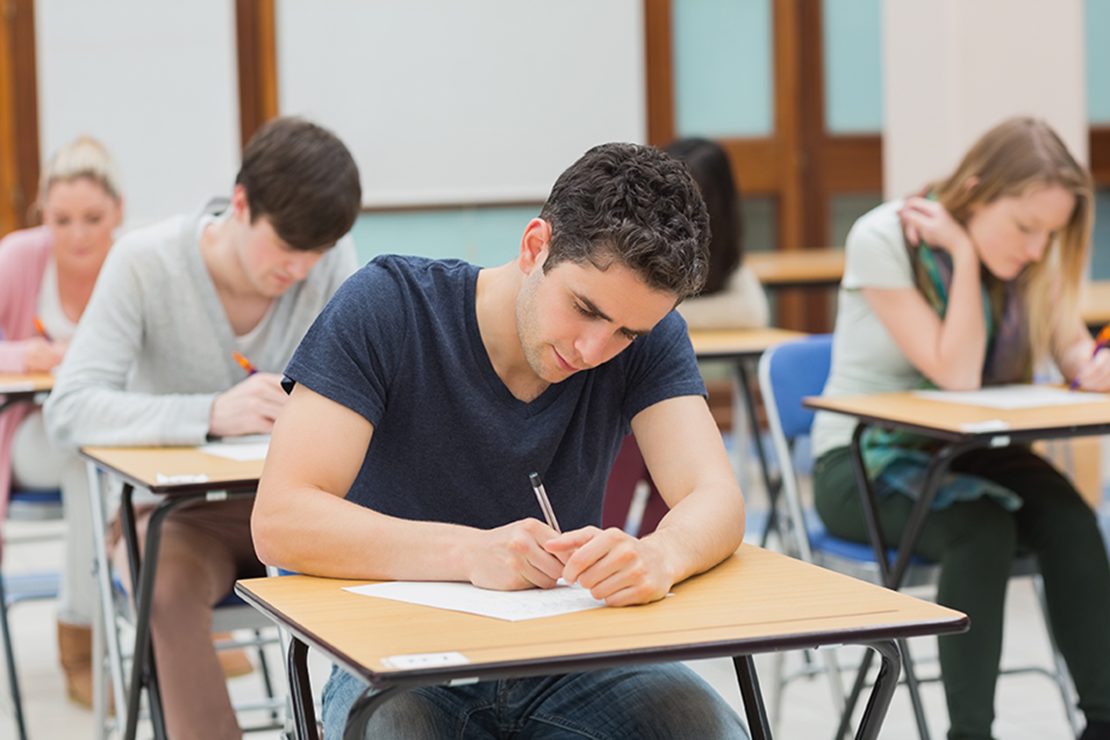 Students sat at a desk during an examination